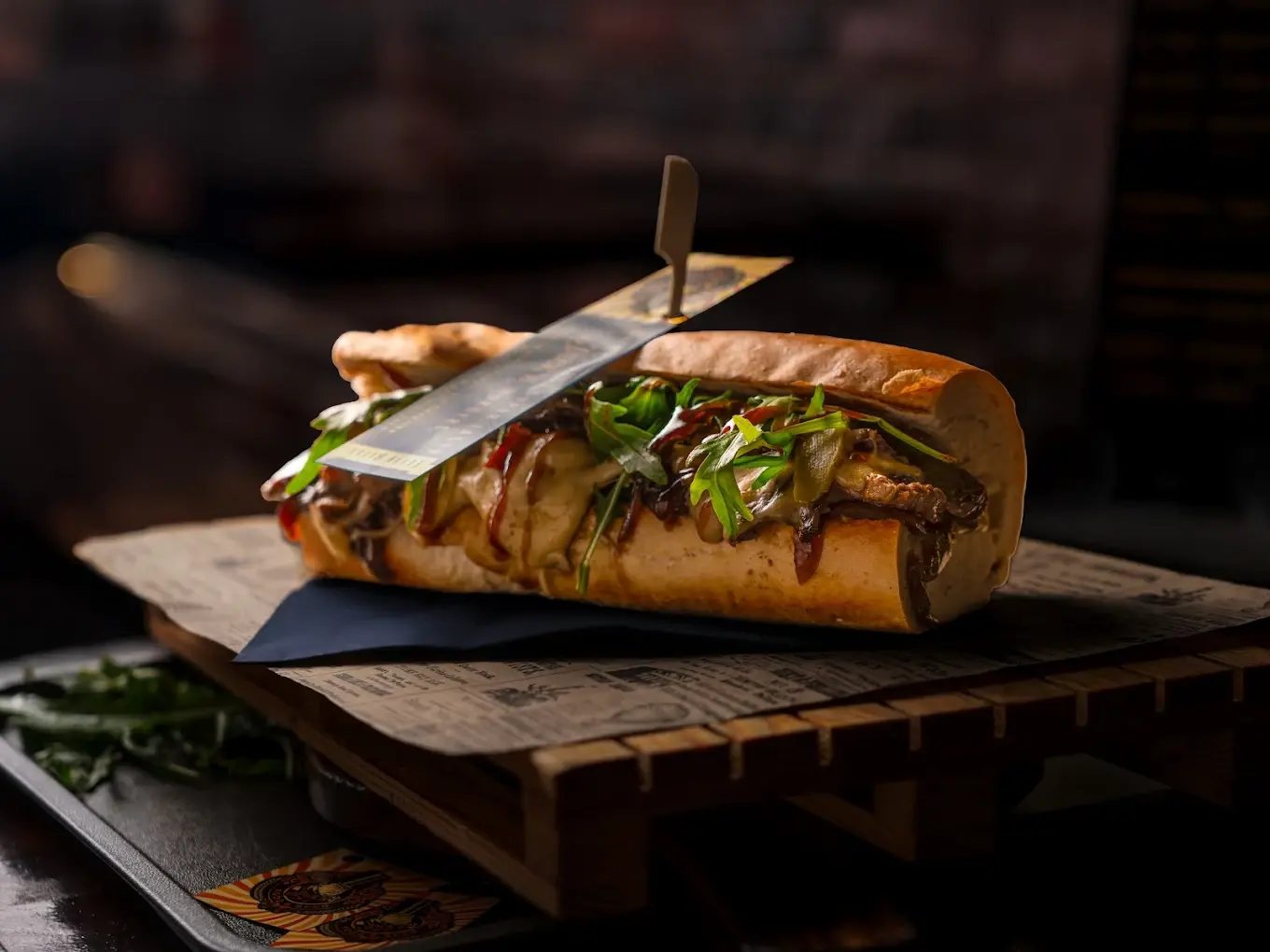 Burger on a plate with vegetables, meat and sauce