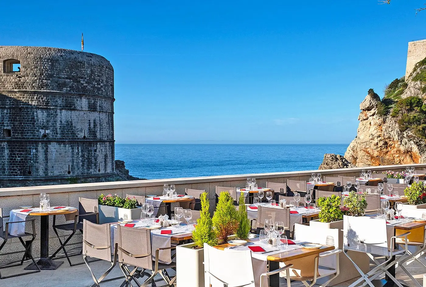 terrace of the restaurant with sea and fortess in background