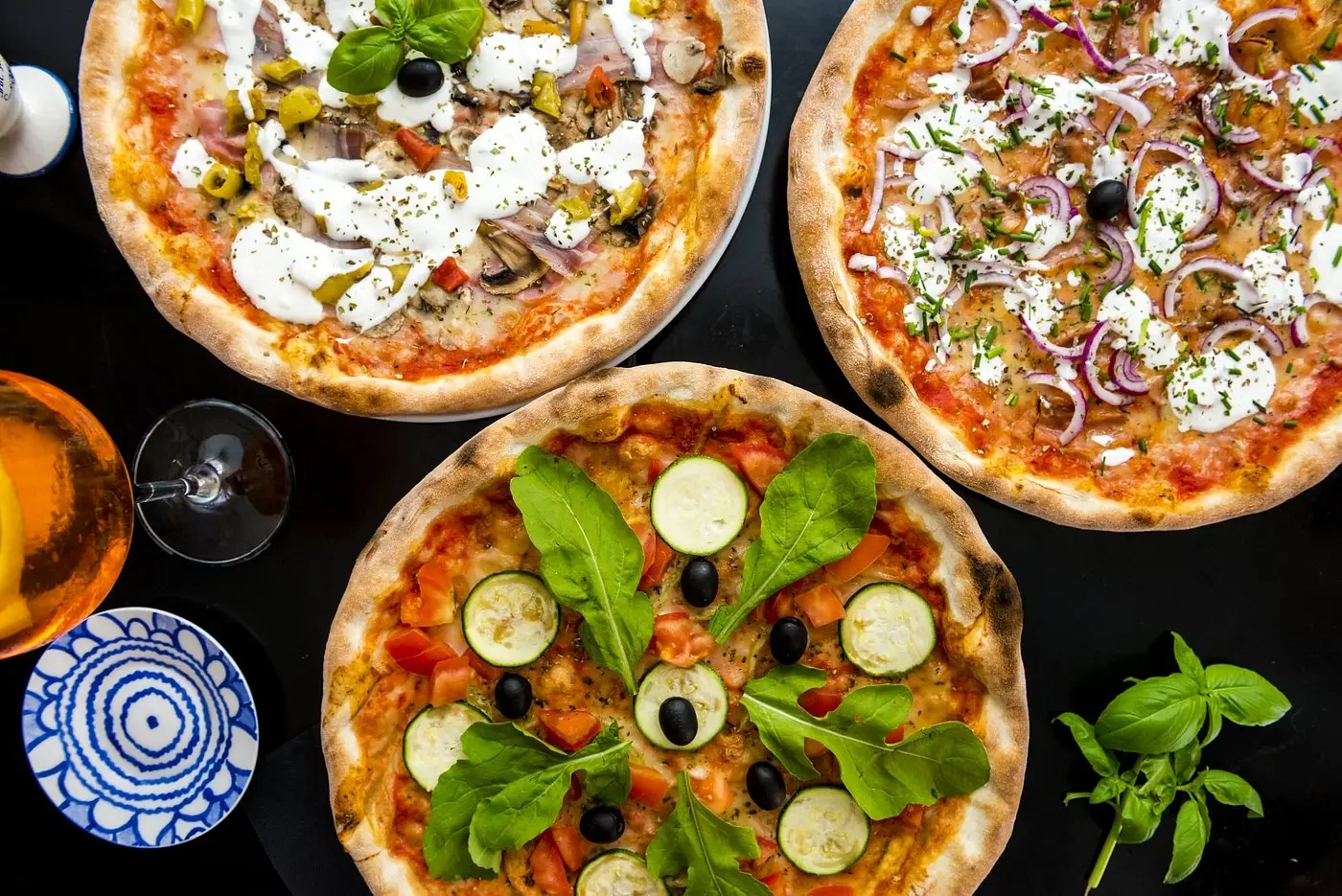 Three versions of a pizza with different toppings