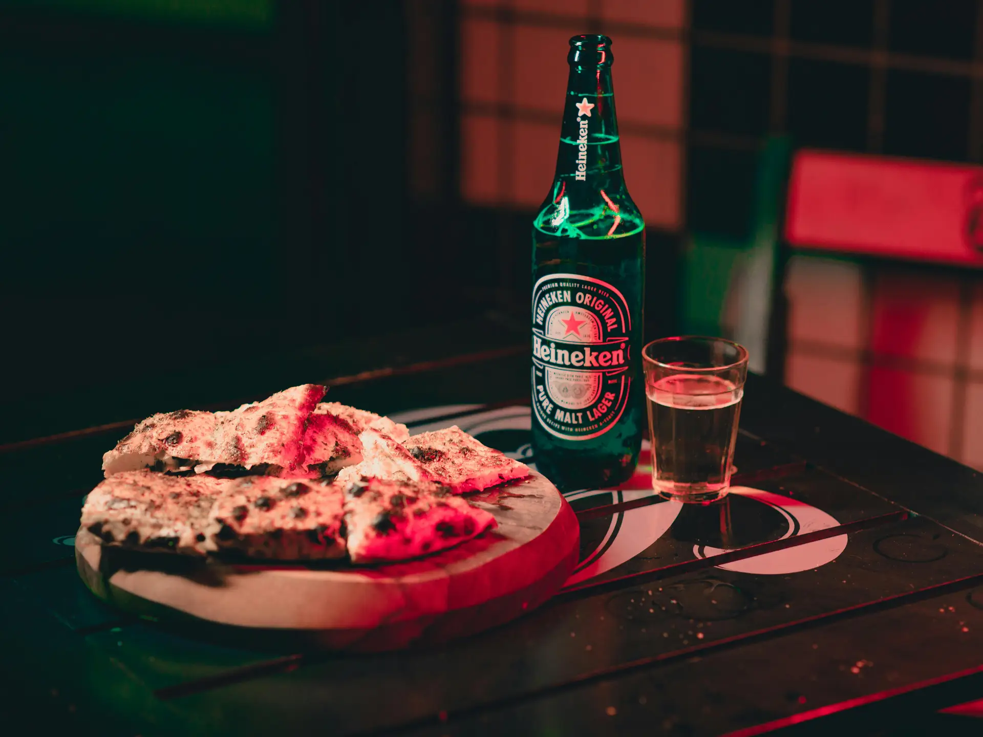 Pizza and beer in bottle and glass athe table