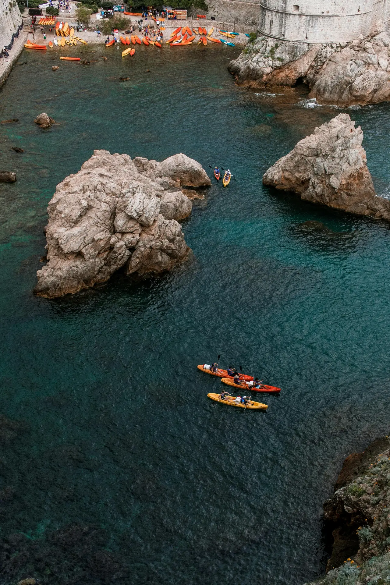 kayaks at the beach surrounded by sea and town