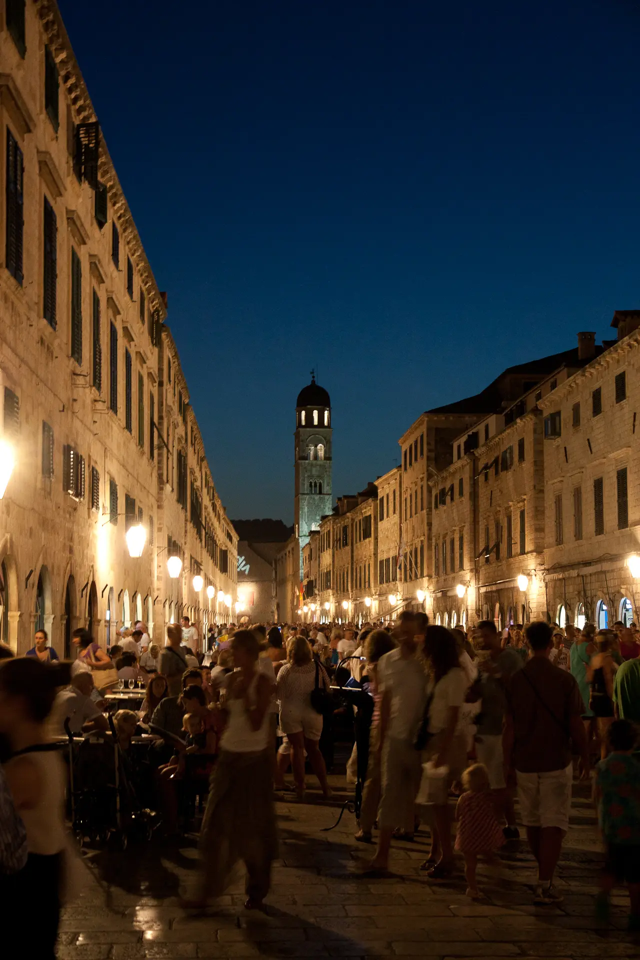 a city street at night with a lot of people