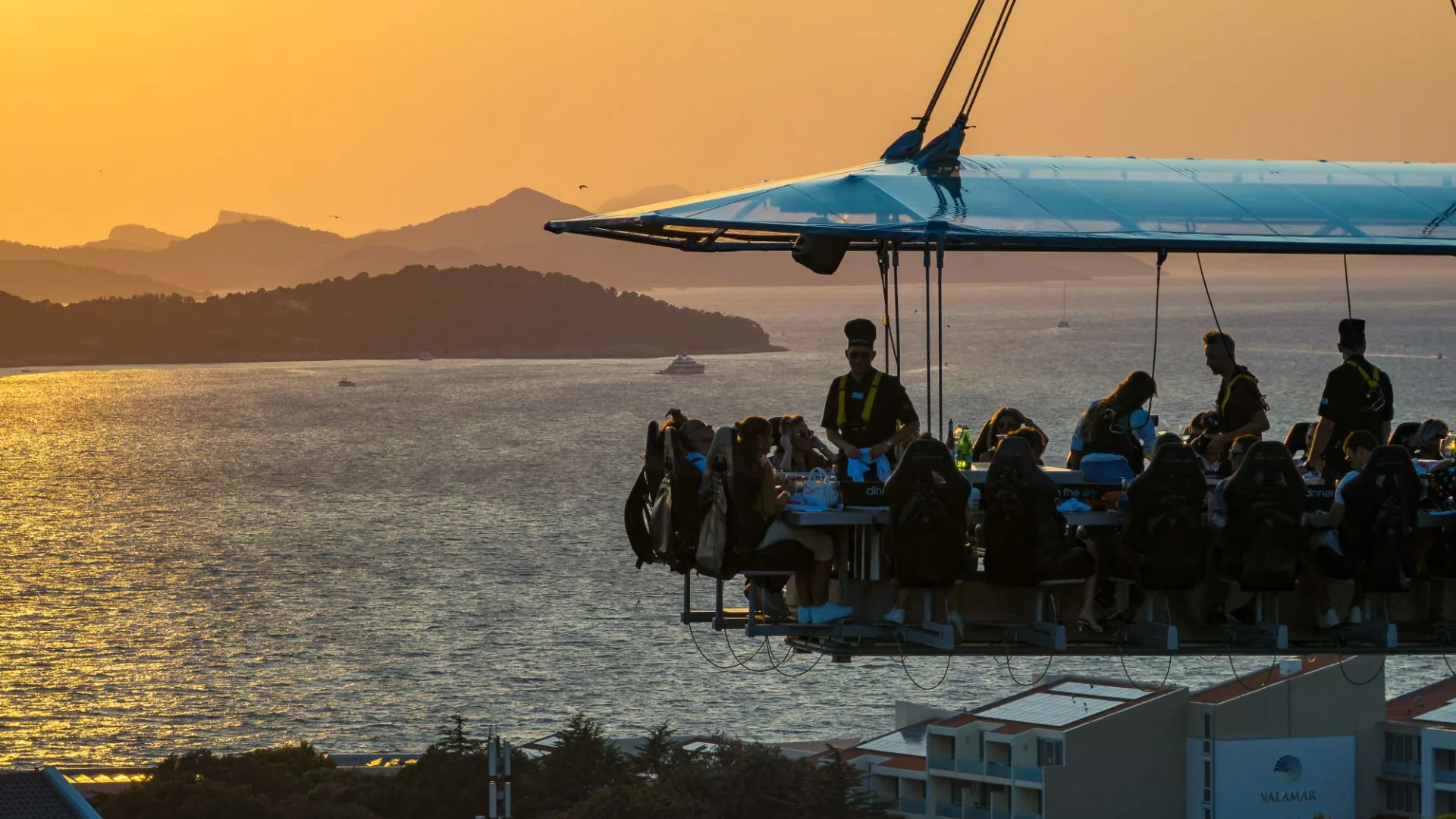 People eating in the sky surounded by the sae