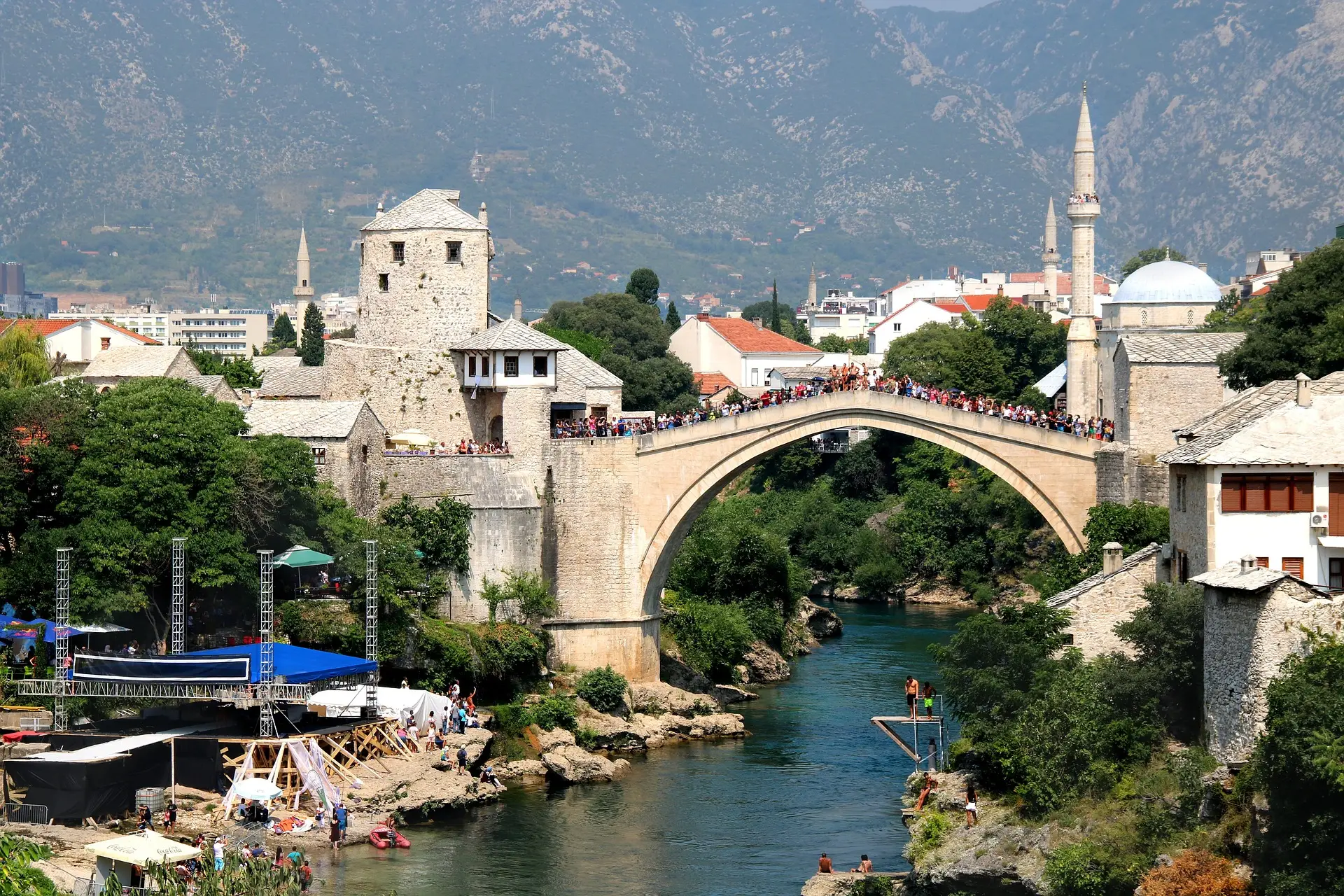 people standing on a bridge abowe river