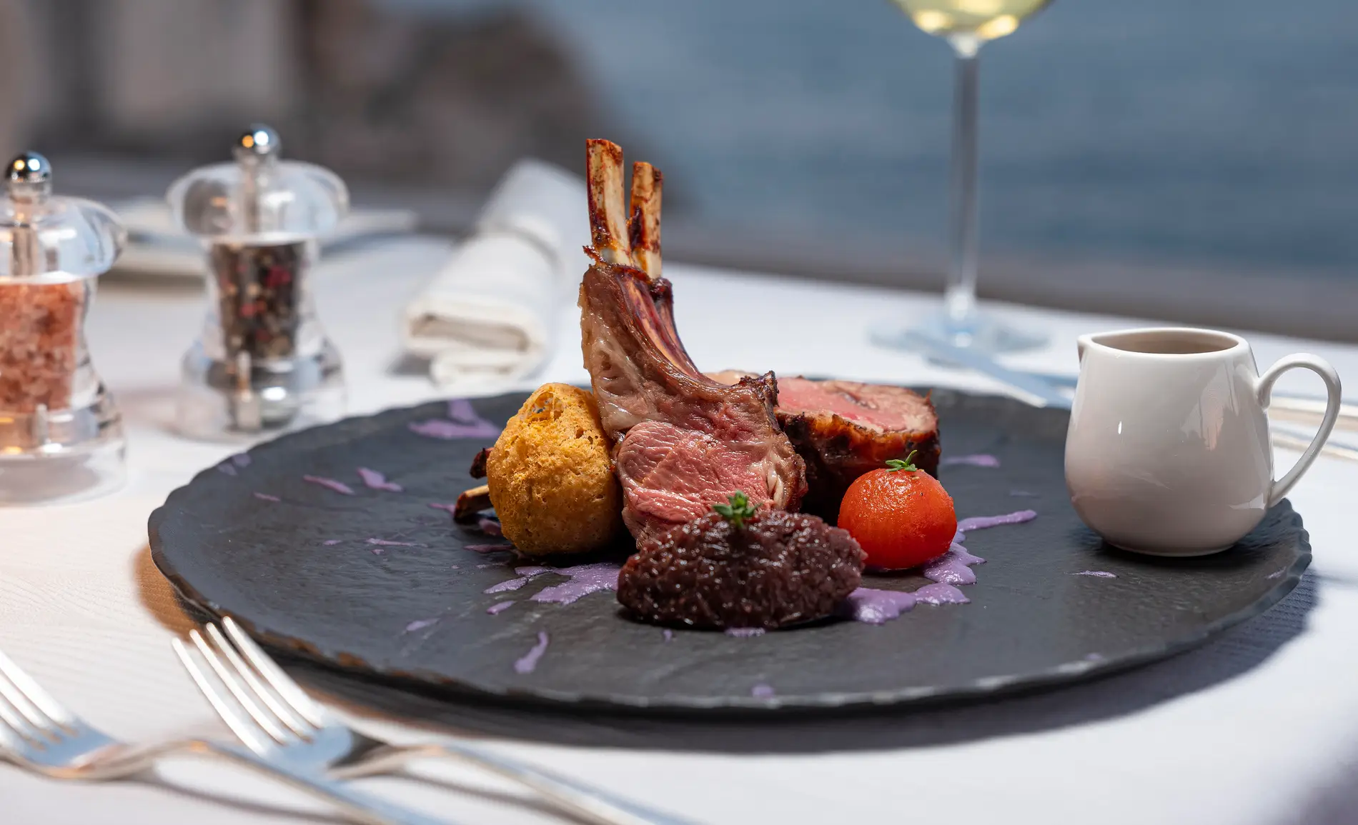 meat and vegetables on a plate at the table with spices