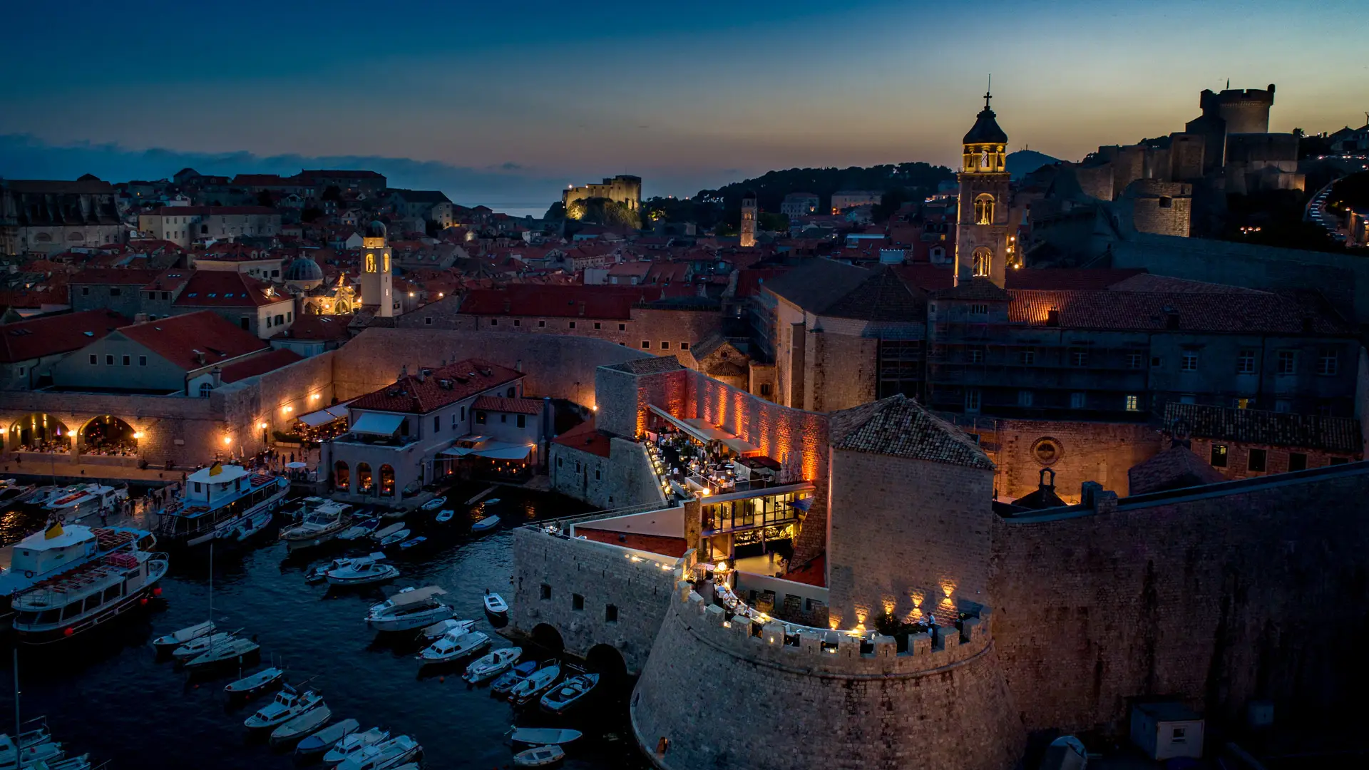 earial view of a restaurant and harbour and city walls